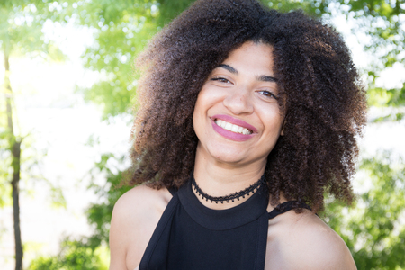 mixed american beautiful girl smiling and nice with a vegetable backgroundの写真素材
