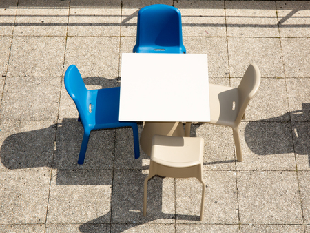 small terrace with 2 blue chairs and two white chairsの写真素材