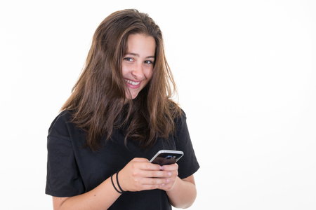 Young woman using a smart phone with smileの写真素材