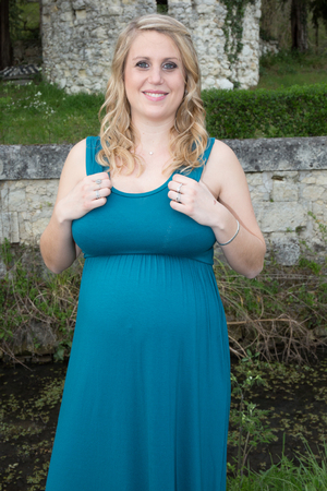Beautiful pregnant woman relaxing in the parkの写真素材