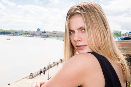 a beautiful young girl sitting sadlyの写真素材