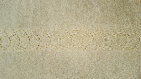 Tire tracks in the sand of a beachの写真素材