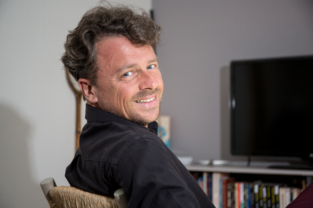 Portrait of handsome Attractive smiling man relaxing at homeの写真素材