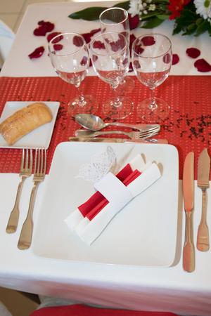 Beautiful glass with rose leafs, rose petals on a romantic date with wine celebrating couple  romantic date dinerの写真素材