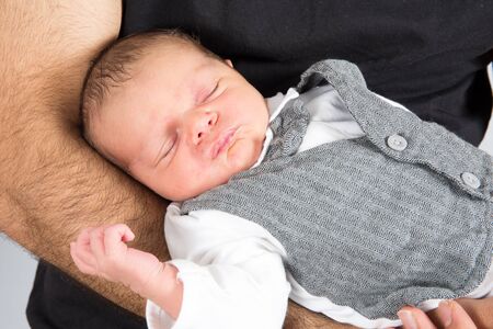 Close up portrait newborn baby in father hands