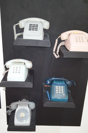 a lot of old vintage collector telephone phone on floors