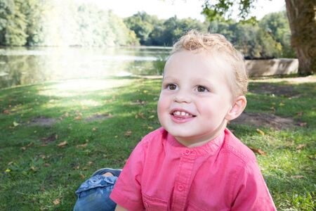 Portrait of a happy little boy in the park