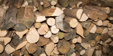 pile of wood logs make natural pattern or texture background in panorama format