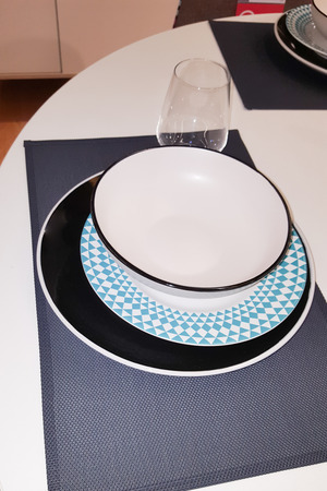 blue and white plate on table for diner at home eat soup