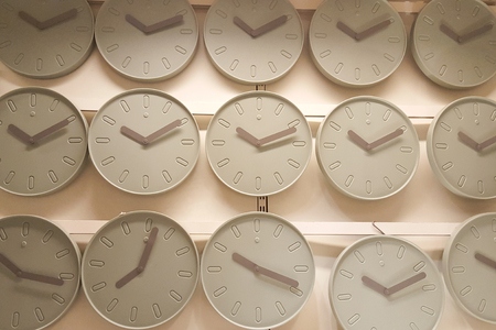 many wall clocks light green grey backgroundの写真素材