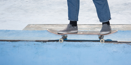 Closeup of man legs with extreme sport concept skateboardの写真素材