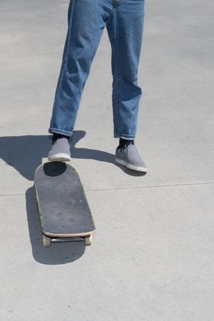 young boy throws himself to skateboard on the streetの写真素材