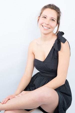 Slim young cute fashion model in black dressの写真素材