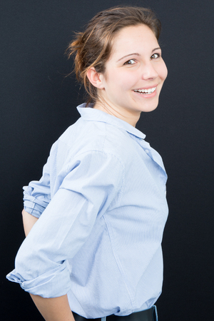 Portrait of a beautiful young woman with a cool makeup and good skin. Studio, black background.の写真素材