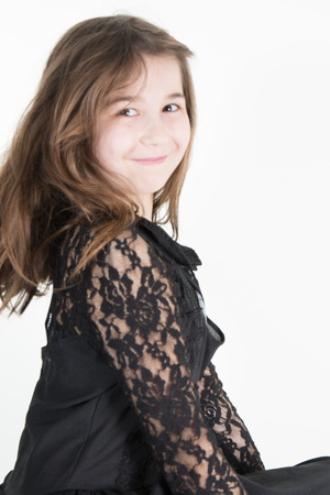 Young girl poses for a picture. Isolated on white backgroundの写真素材