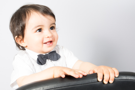 Adorable boy child looking up isolated on grey backgroundの写真素材