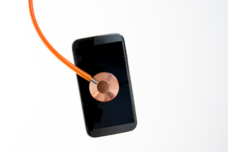 Conceptual image of stethoscope and mobile phone diagnosed Modern Disease Medical Research or Phone repair and service conceptの写真素材