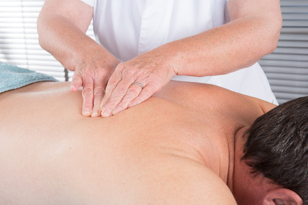 Man having a back massage in spa wellness centerの写真素材