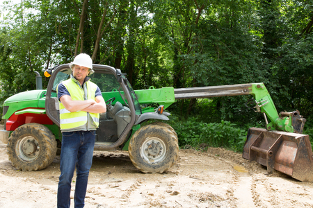 a man on a construction site in front of an excavator