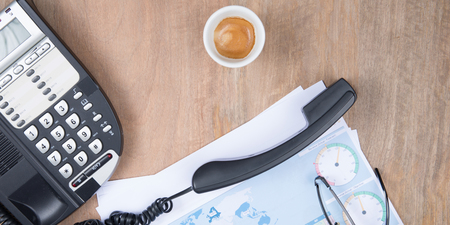 flat lay phone hooked up on the desk coffee and a statistical document top viewの写真素材