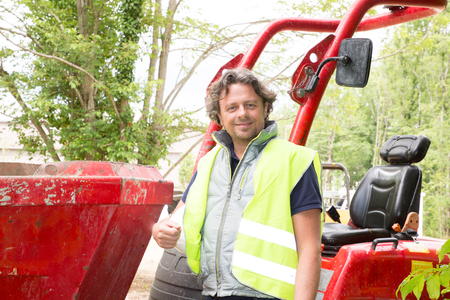 happy smiling construction industrial machine operator man on siteの写真素材