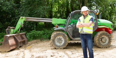 man worker operating excavator on construction site
