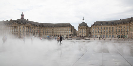 Bordeaux, Aquitaine / France - 06 10 2018 : woman girl play fun in mirror fountain in front of Place de la Bourse in Bordeaux, Franceのeditorial素材