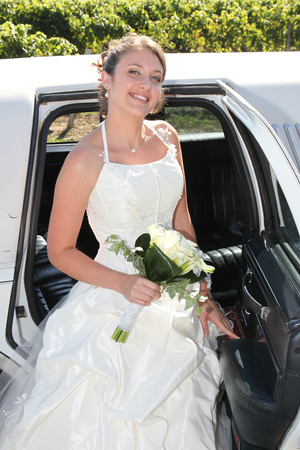 beautiful tender wedding bouquet of cream roses flowers in hands of the bride go out of marriage carの写真素材