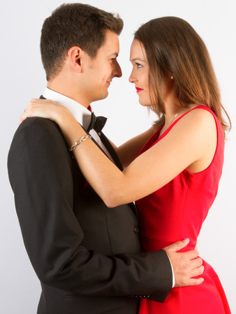 Fashionable picture of young people couple elegant kiss and hug in loveの写真素材