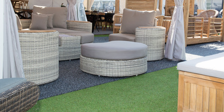 Outdoor patio with empty round chair and table in garden