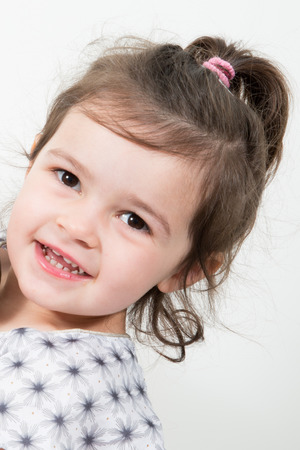 Portrait of beautiful little girl happy smiling on studio Isolated in white backgroundの写真素材