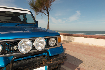 blue all-terrain car parked at the beach paradiseの写真素材