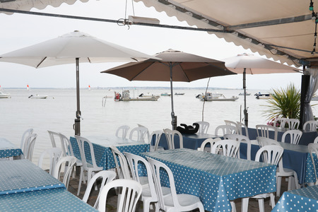 restaurant terrace at an oyster farmer at the foot of the ocean to eat oystersの写真素材