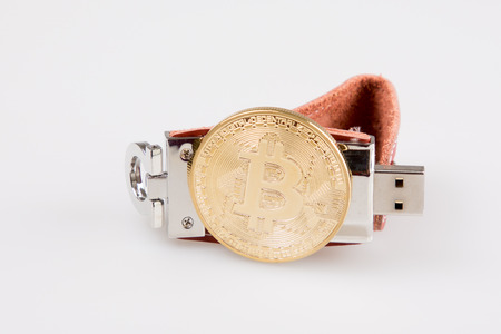 leather bitcoin and usb flash drive isolated on white