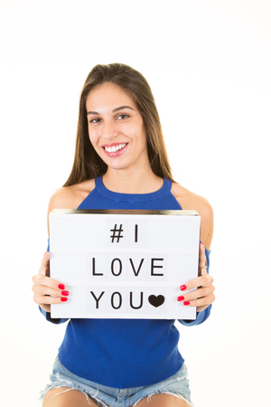 beauty young woman with white sign i love you for mother day or wedding boyfriendの写真素材