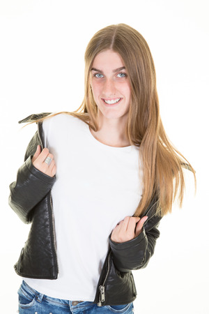 smiling young girl with leather jacket open to white empty shirtの写真素材