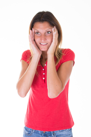pretty fit woman headache with head in hands on white backgroundの写真素材