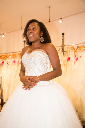 black bride try fit her wedding dress on in clothes shopの写真素材