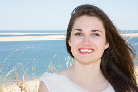 beautiful smiling young woman in summer beach on sea vacationの写真素材