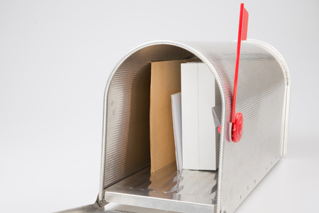 open mailbox with white gift box and correspondence isolated on grey backgroundの写真素材