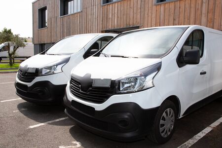 two white van front of warehouse reday for delivery parcelの写真素材