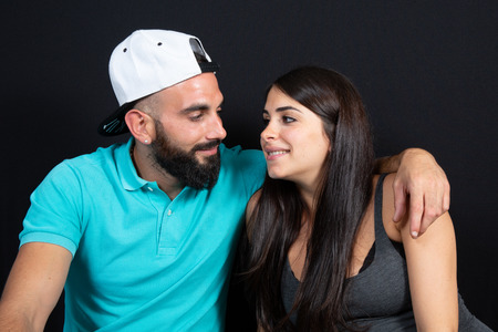 arabic couple man with bearded and cap with pretty woman beauty arab in lifestyle over black...