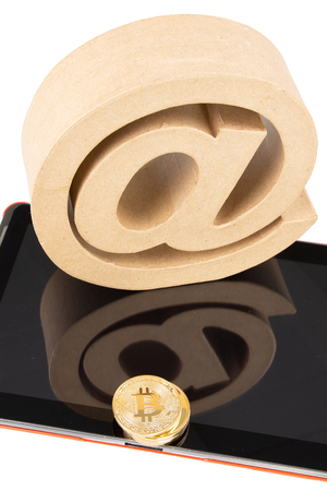 black screen tablet with coin gold bitcoin digital money with arobase signの写真素材