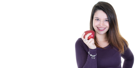 beautiful young woman holding an apple with side blank white copyspace backgroundの写真素材