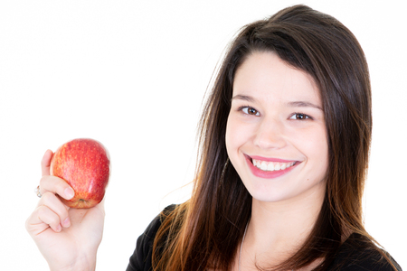 young pretty woman hold red apple on white backgroundの写真素材