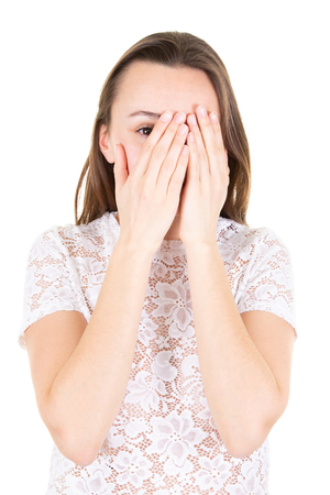 young girl with long hair covers his face with his handsの写真素材