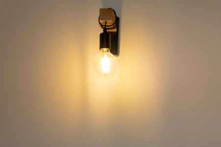 Electric lamp hanging on wood wire in wall roomの写真素材