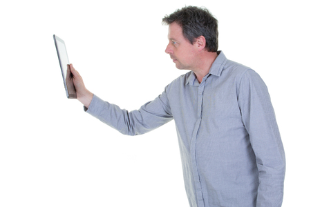 handsome middle aged man using a digital tablet on white backgroundの写真素材