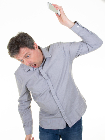 angry caucasian man frustrated and furious with his phone conflict with customer service over white backgroundの写真素材