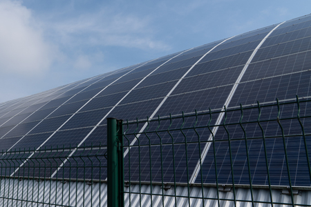 solar panels round with sun in industryの写真素材